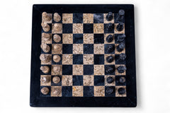Black and brown stone chess set on a white background