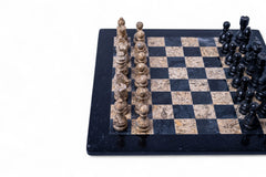 Marble chess set with black and white pieces on a checkered board