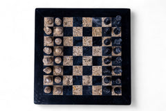 Checkered game board with stone pieces on a white background