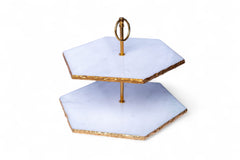 Two-tiered serving tray with gold accents on a white background