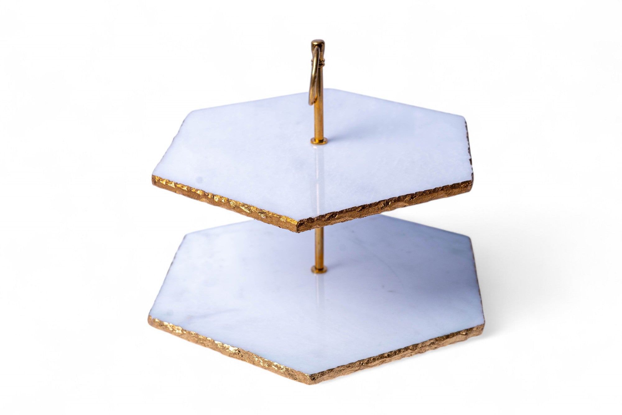 Two-tiered cake stand with gold accents on a white background