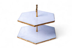 Two-tiered cake stand with gold accents on a white background