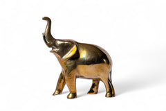 Brass elephant figurine on a white background