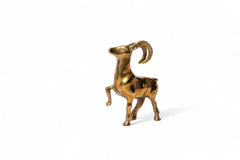 Gold ram figurine on a white background