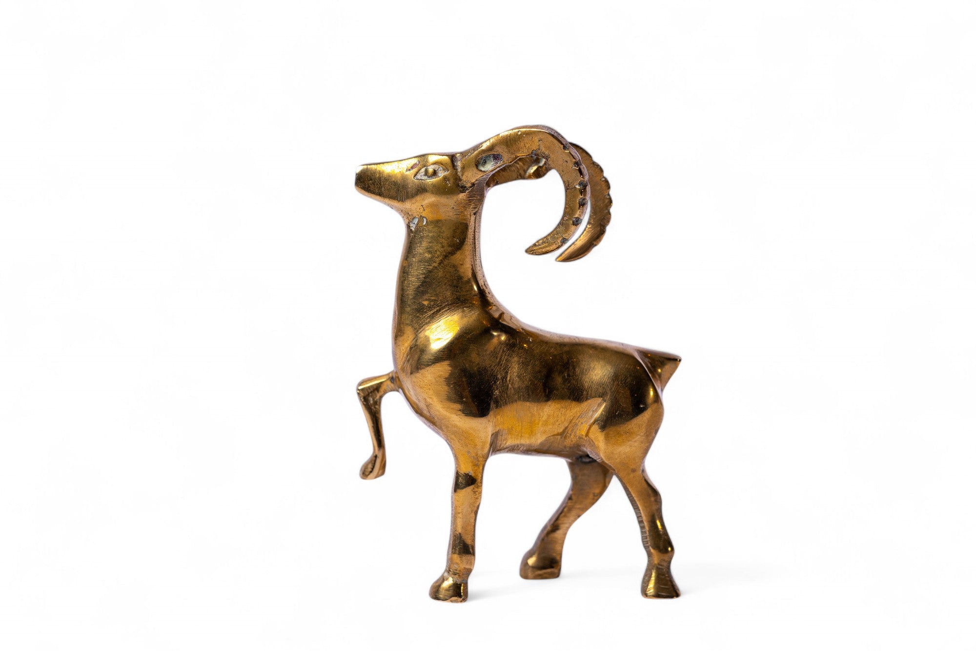 Brass goat figurine on a white background