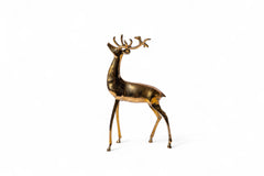 Decorative brass deer figure on a white background