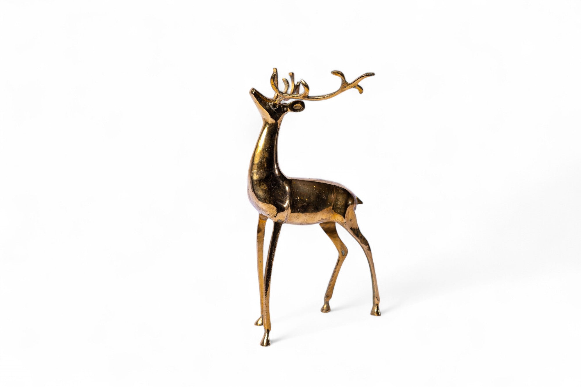 Gold deer figurine on a white background