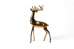 Brass deer figurine on a white background