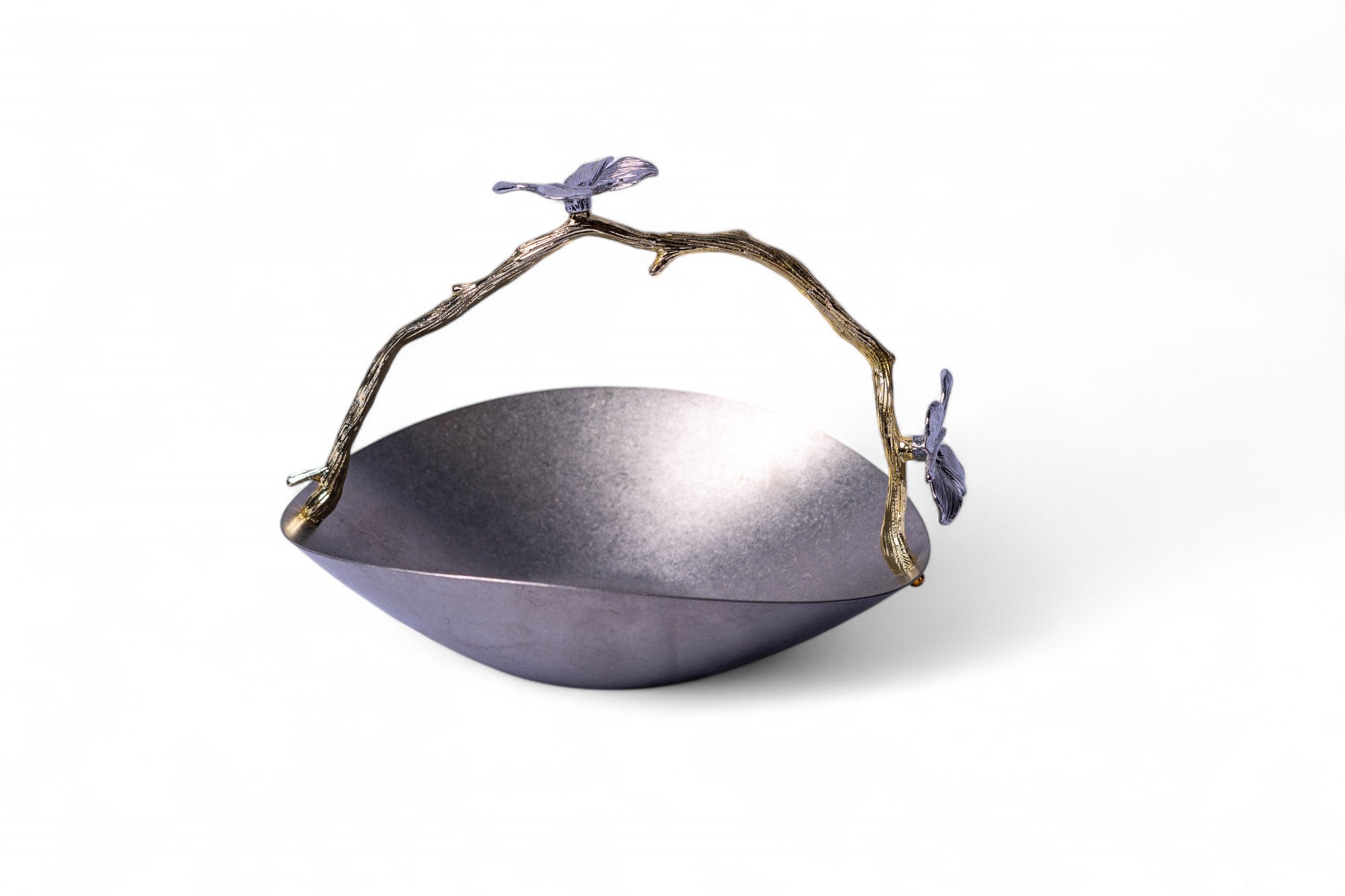 Decorative metal bowl with branch handle and bird accents on a white background