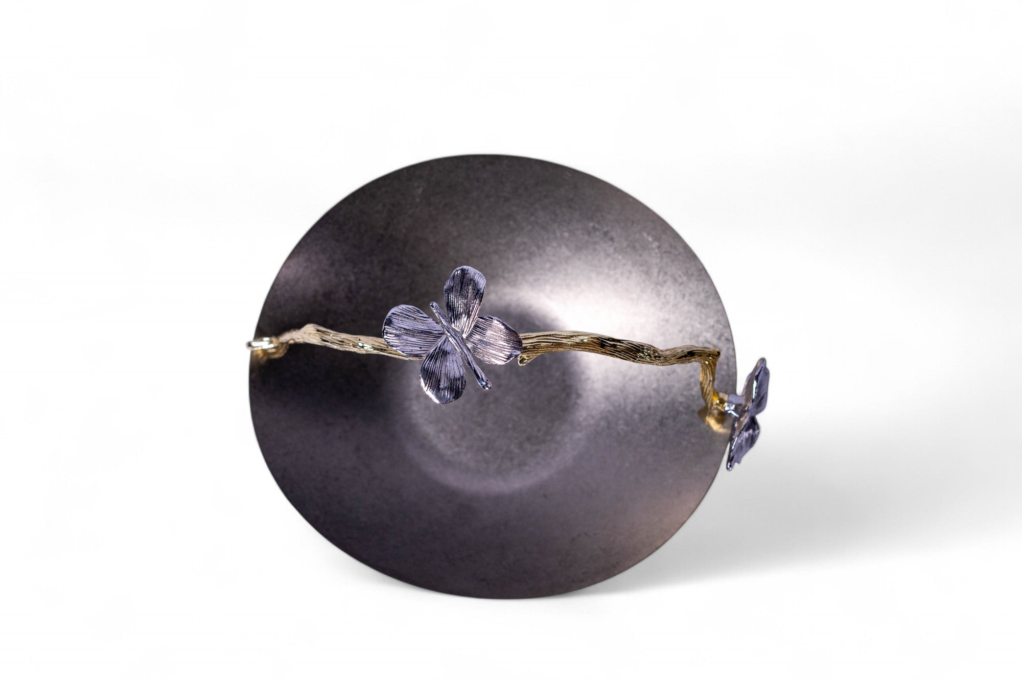 Jewelry with butterfly-shaped elements on a dark gray sphere