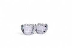 Pair of clear glass candle holders on a white background
