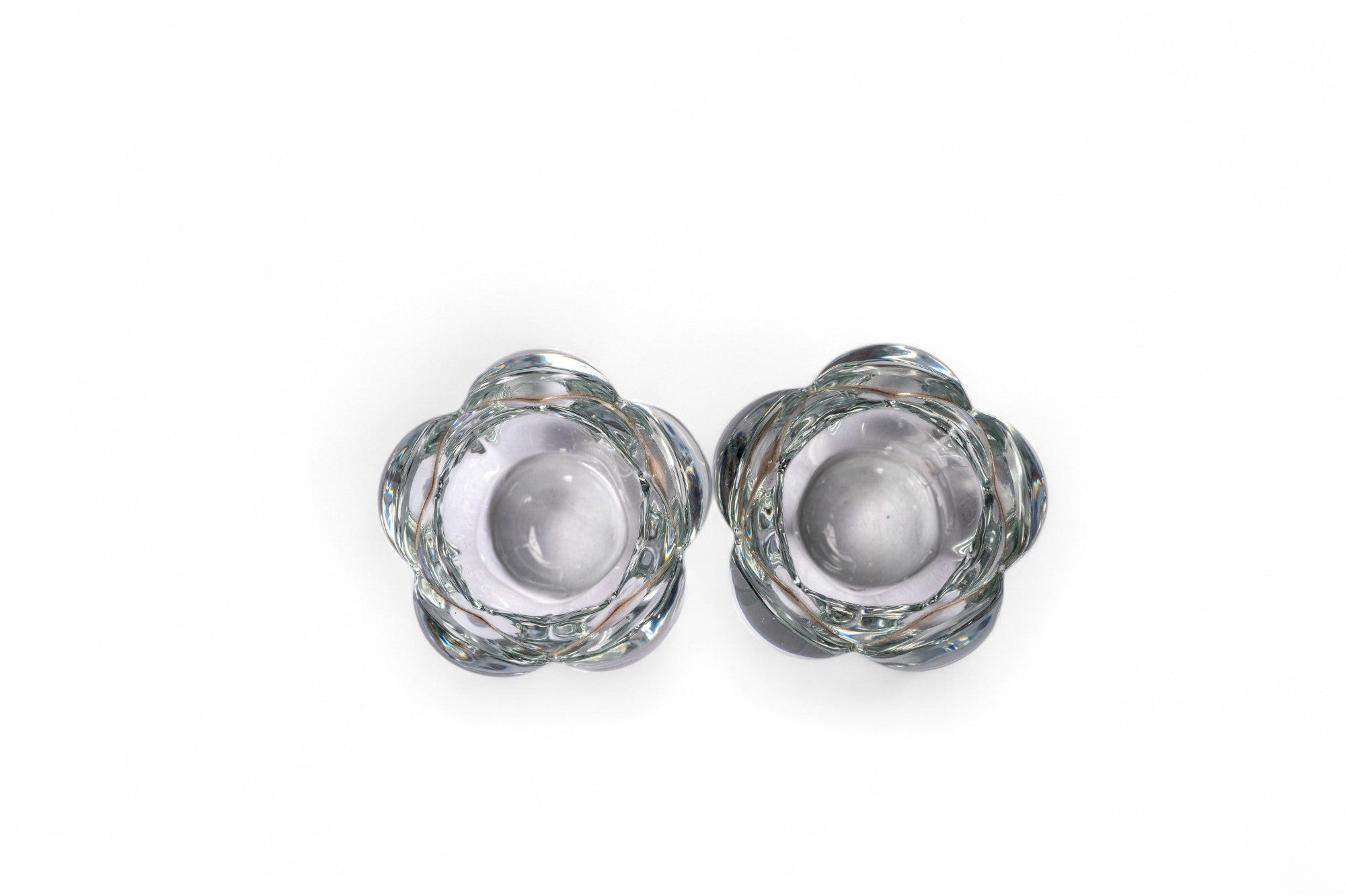 Pair of clear glass candle holders on a white background