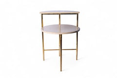 Small round table with gold legs and white marble top on a white background