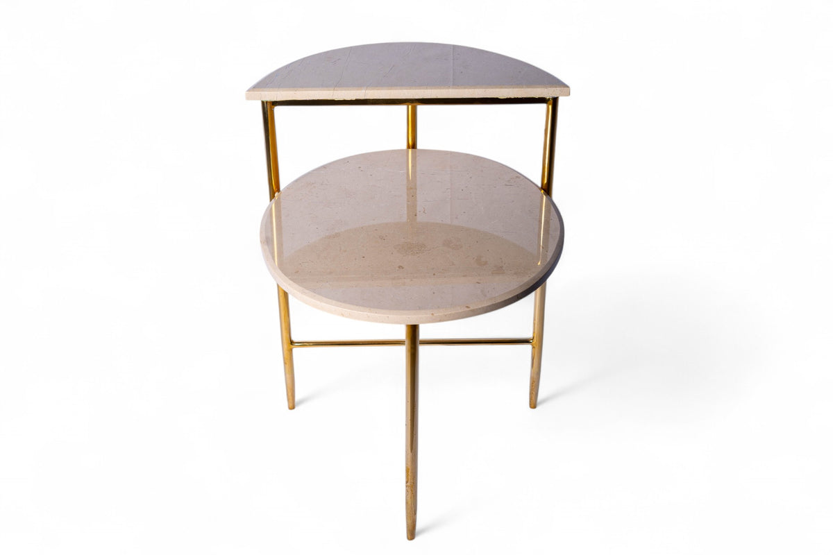 Two-tiered side table with marble top and gold legs on a white background