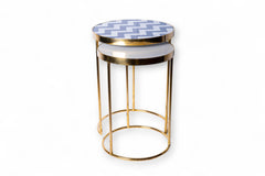 Decorative stool with gold frame and patterned top on a white background