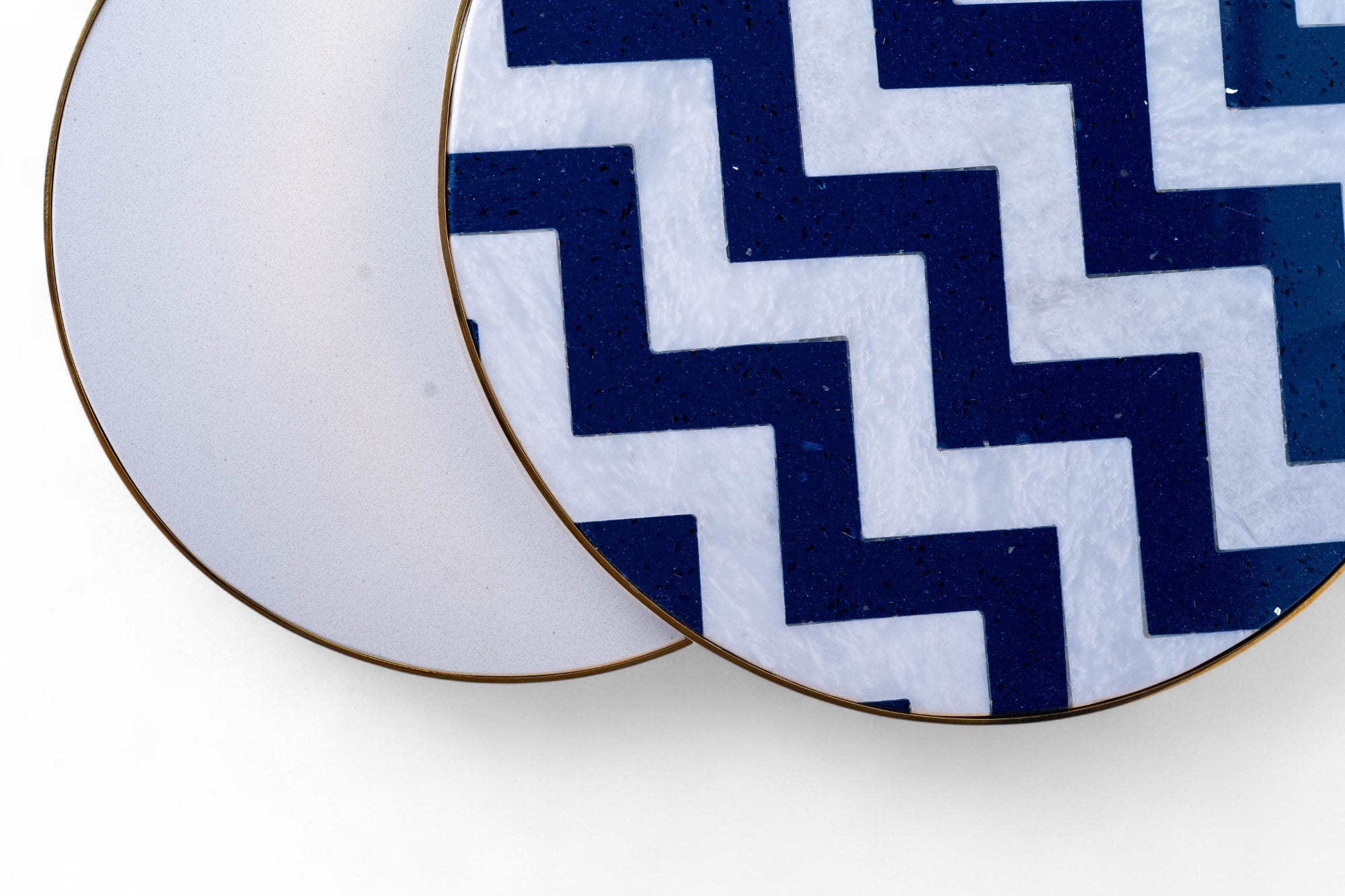Navy blue and white zigzag patterned coasters on a white background