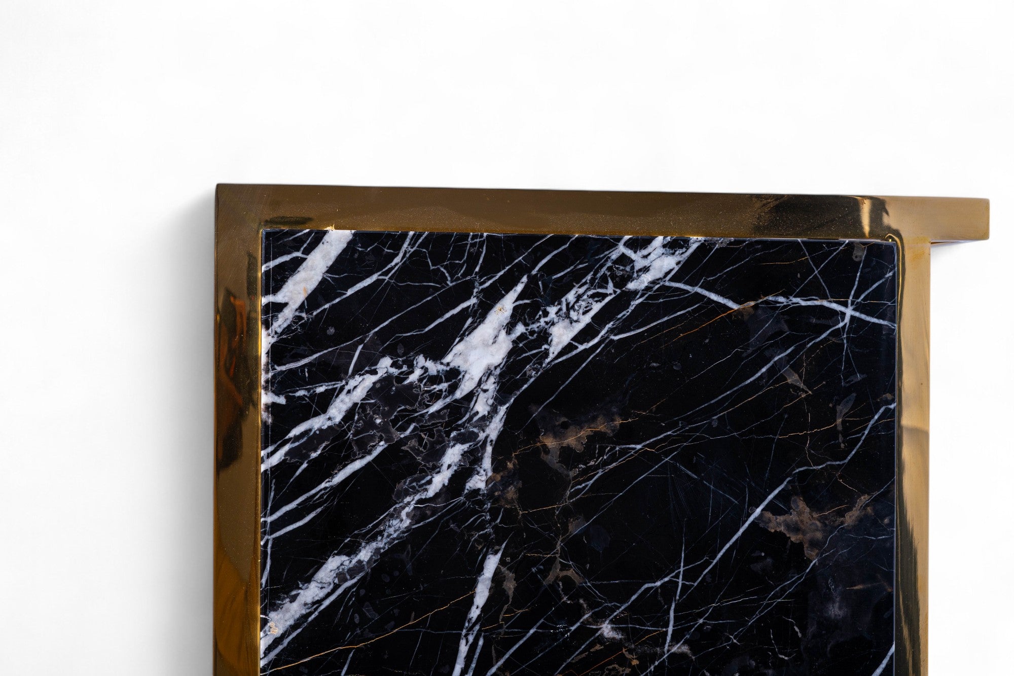 Marble-patterned surface with gold frame on a white background