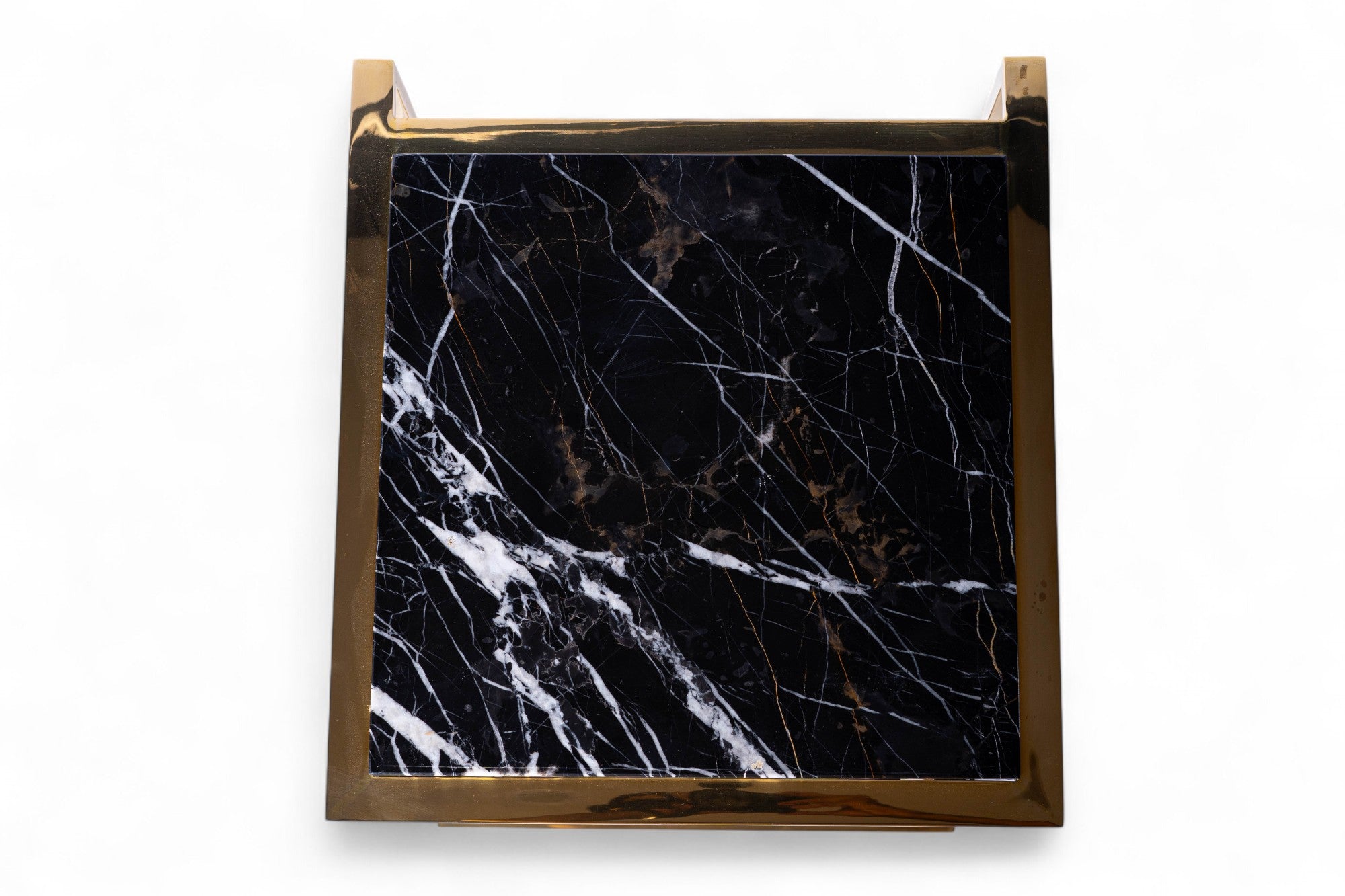 Black marble tile with gold border on a white background