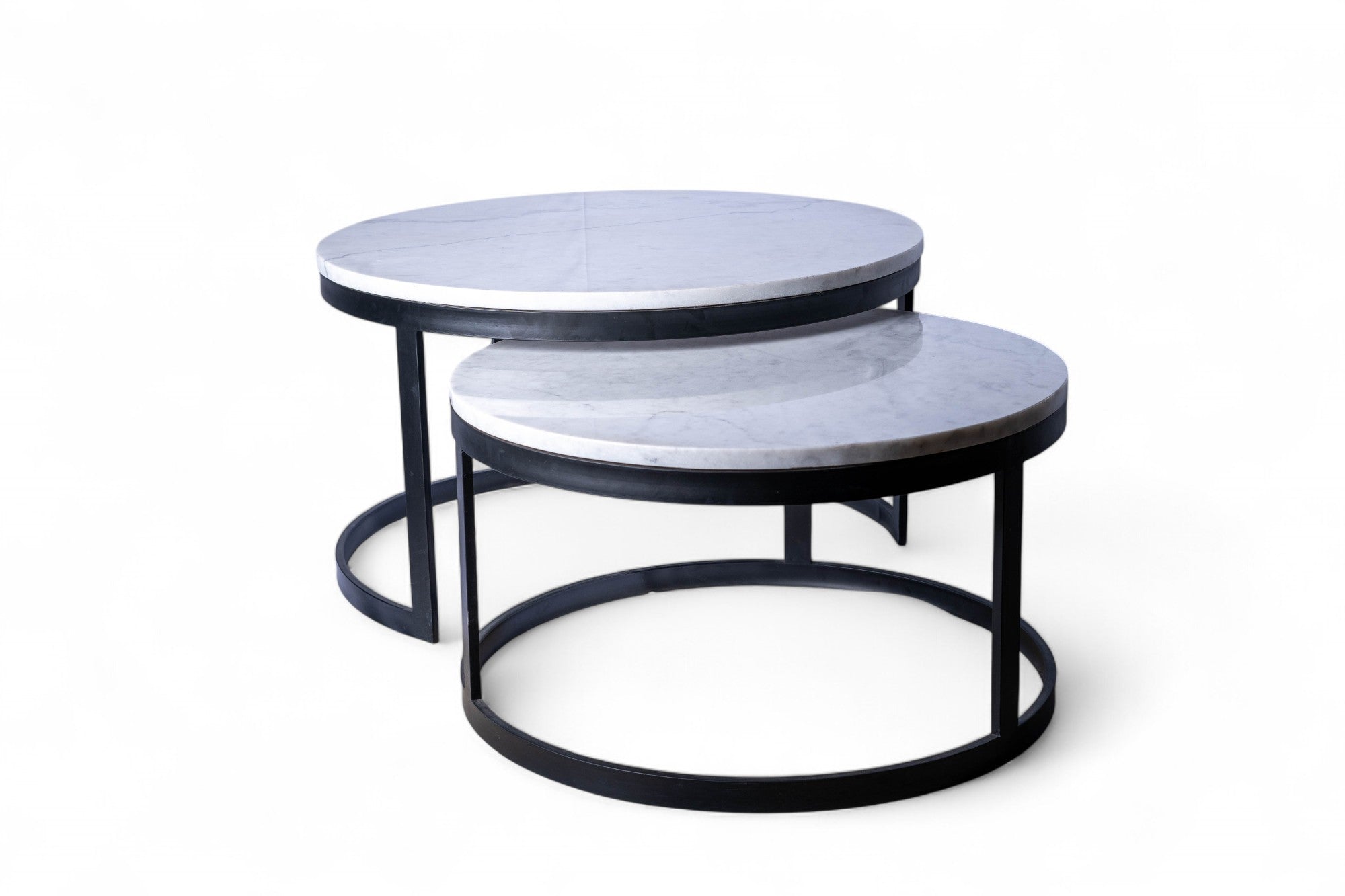 Set of two round marble coffee tables with black metal frames on a white background