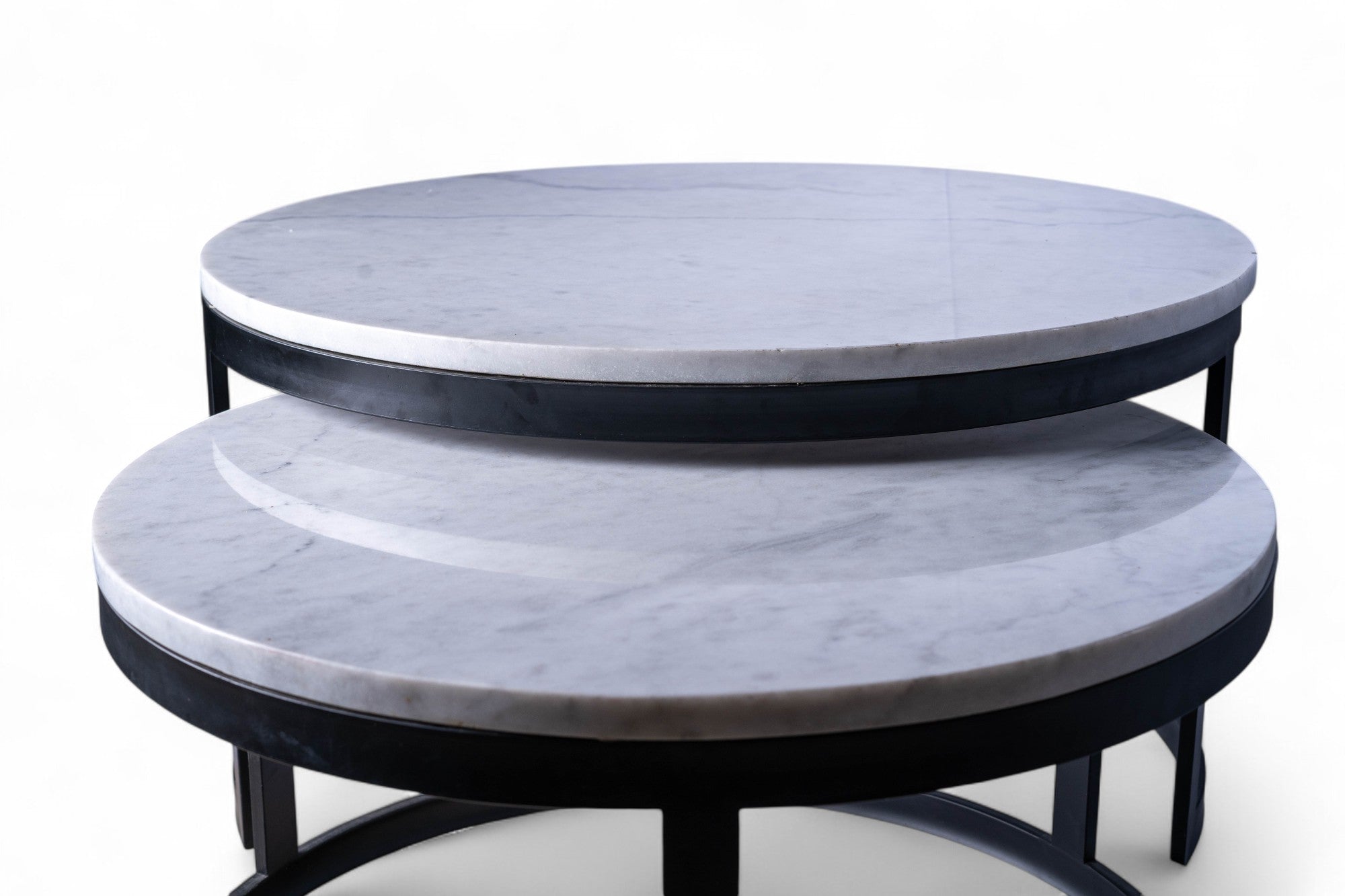 Two round marble tables stacked on top of each other with a white background