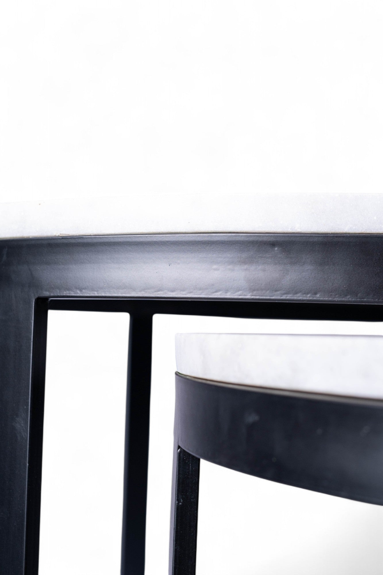 Close-up of a black metal stool on a white background