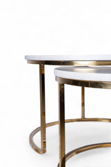 Two round tables with marble tops and gold metal frames on a white background