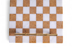 Checkered board with cork and white squares and a gold piece on a white background