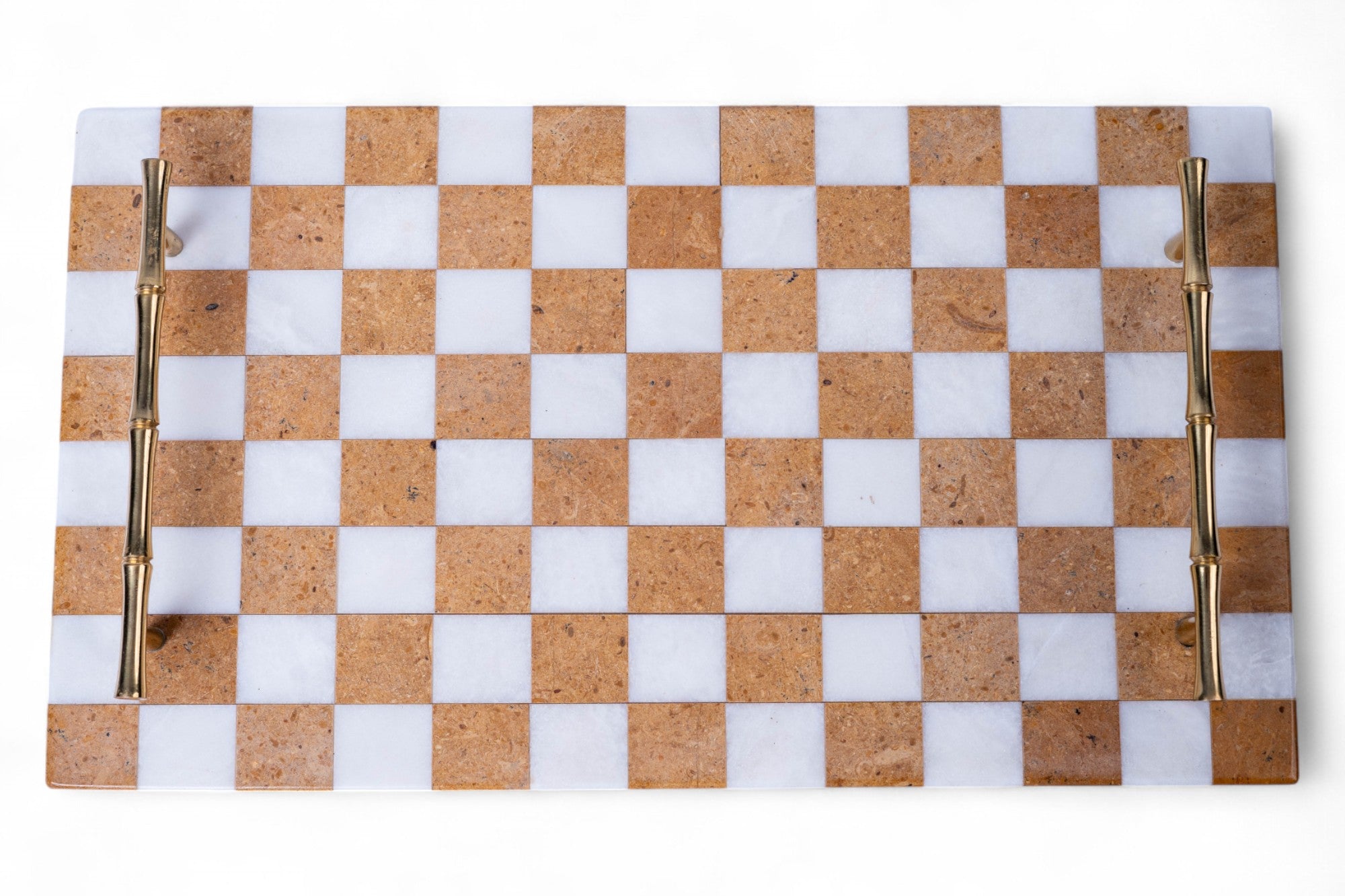 Checkered cutting board with gold handles on a white background
