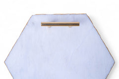 Hexagonal light blue tray with a gold handle on a white background