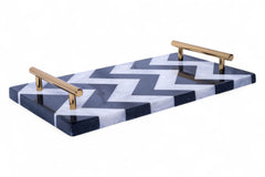 Marble tray with a zigzag pattern and gold handles on a white background
