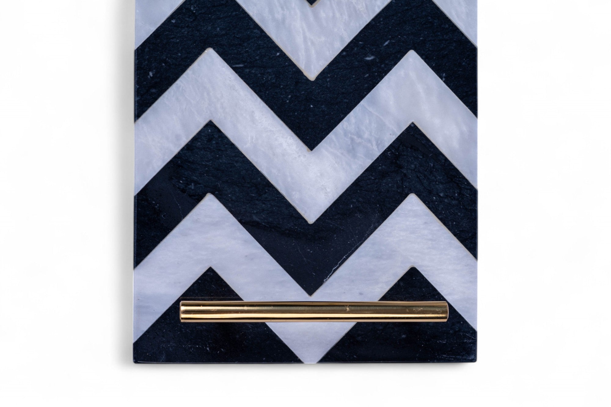 Notebook with black and white chevron pattern cover and gold pen on a white background