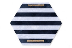 Hexagonal tray with black and white striped pattern and gold handles on a white background