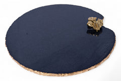 Round dark blue stone coaster with gold decorative element on a white background