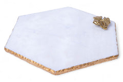 Hexagonal white stone with gold trim and decorative element on a white background
