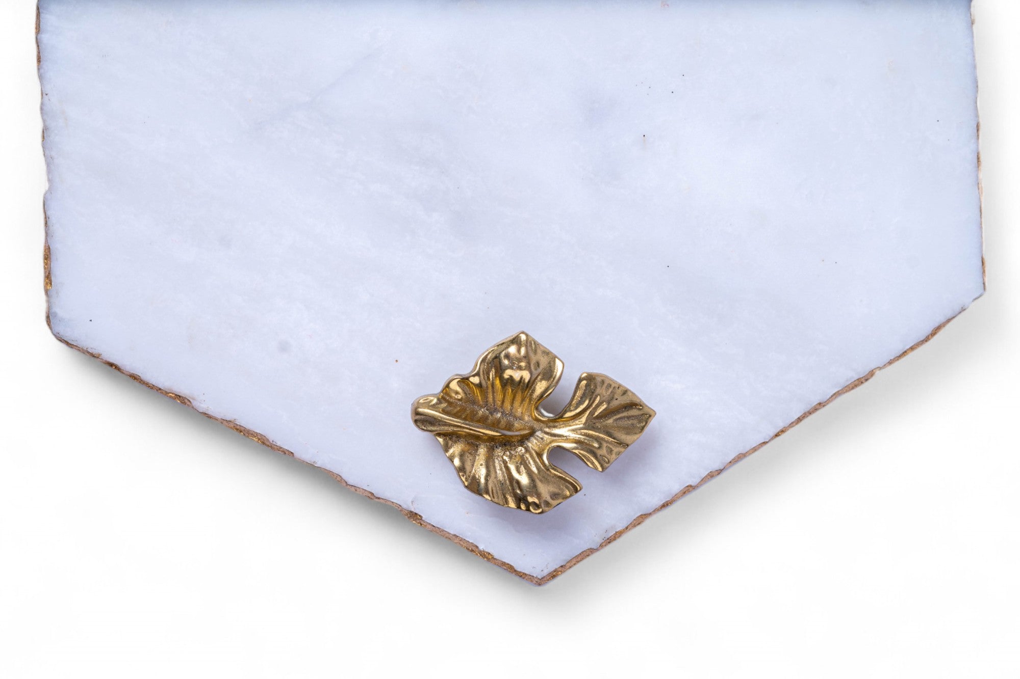 Gold brooch on a light blue fabric background