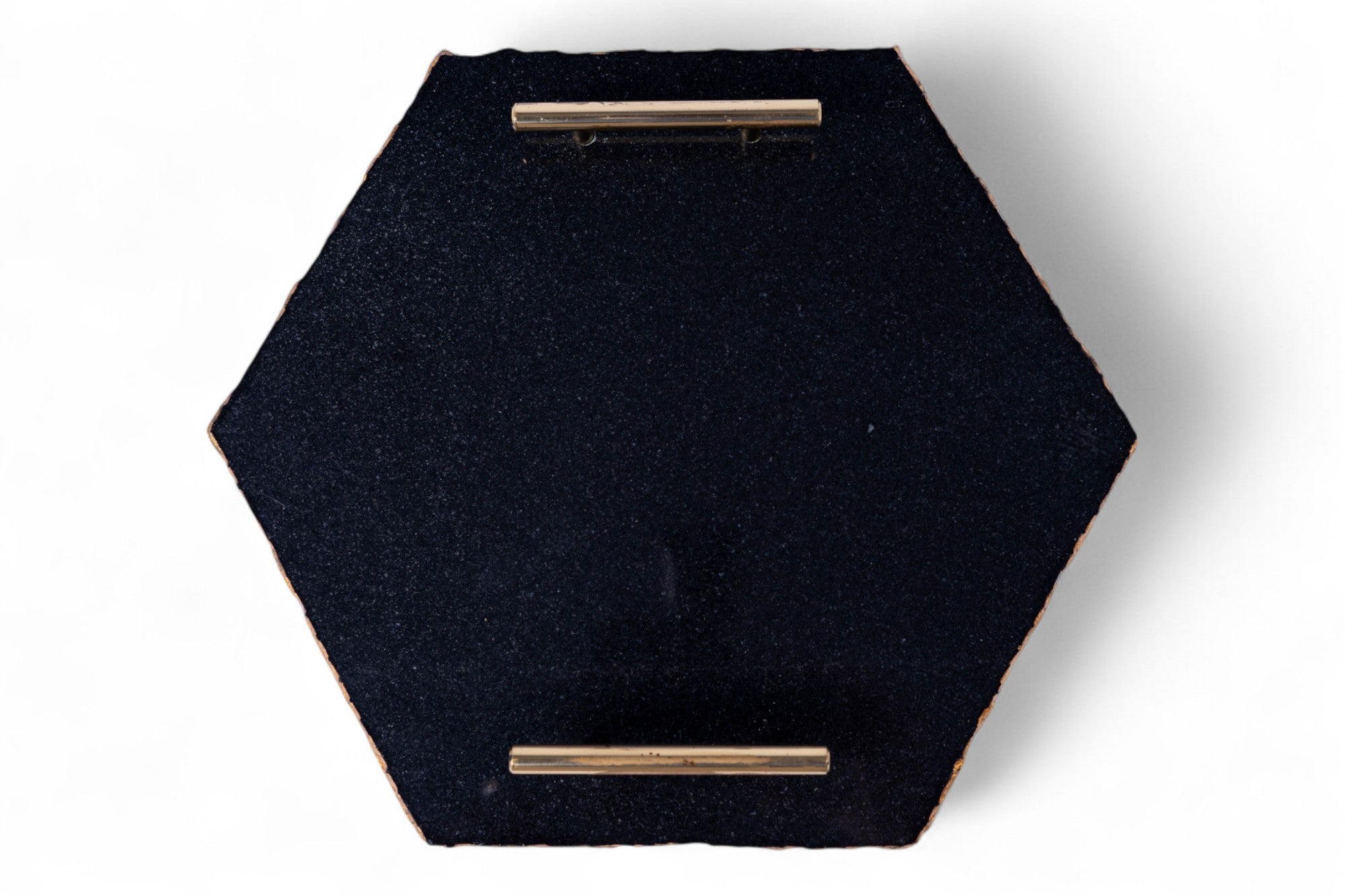 Hexagonal black fabric tray with gold accents on a white background
