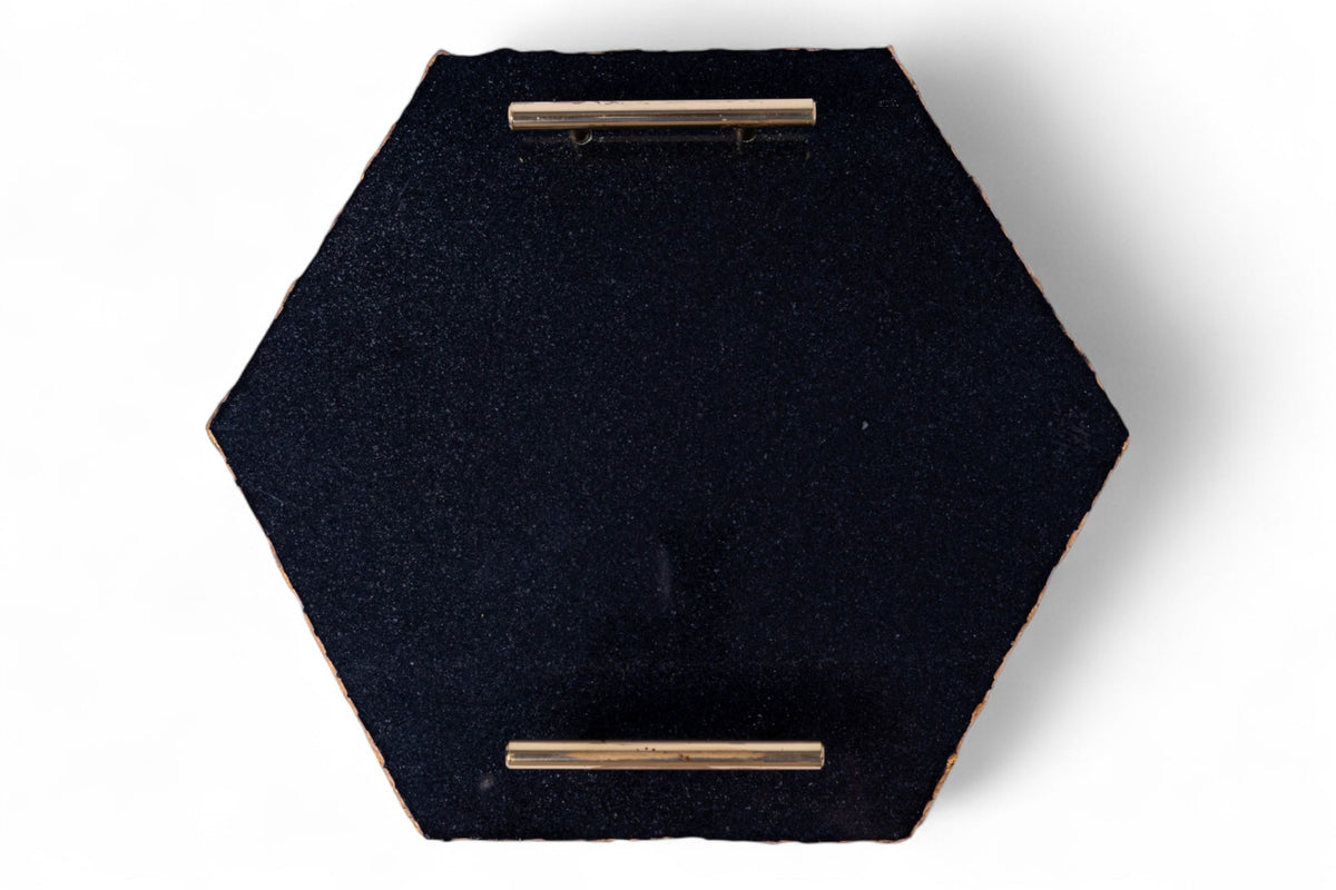 Hexagonal black fabric tray with gold accents on a white background