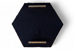 Hexagonal black fabric tray with gold accents on a white background