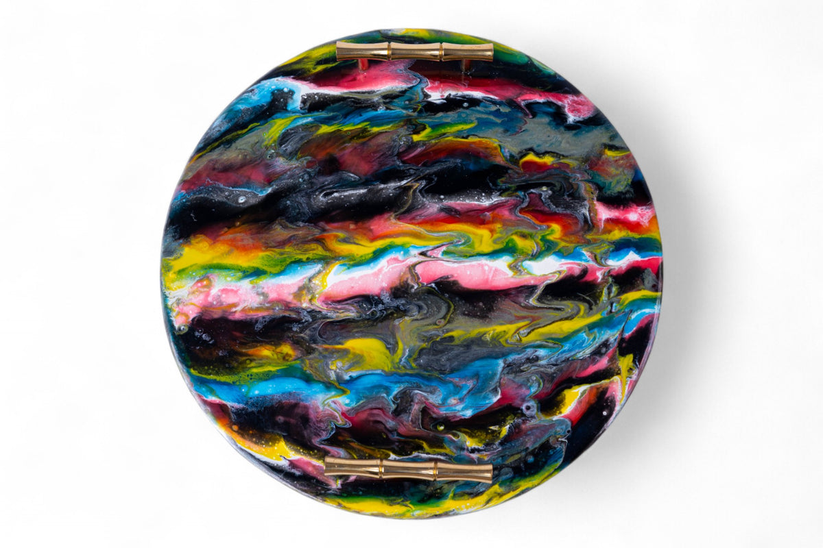 Round, multicolored art piece with gold accents on a white background
