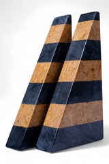 Two wedge-shaped objects with alternating brown and blue stripes on a white background