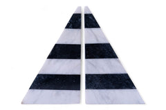 Two triangular marble coasters with black and white stripes on a white background