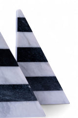 Two triangular marble slabs with black and white stripes on a white background