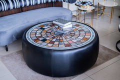 Round coffee table with mosaic top in a modern living room setting