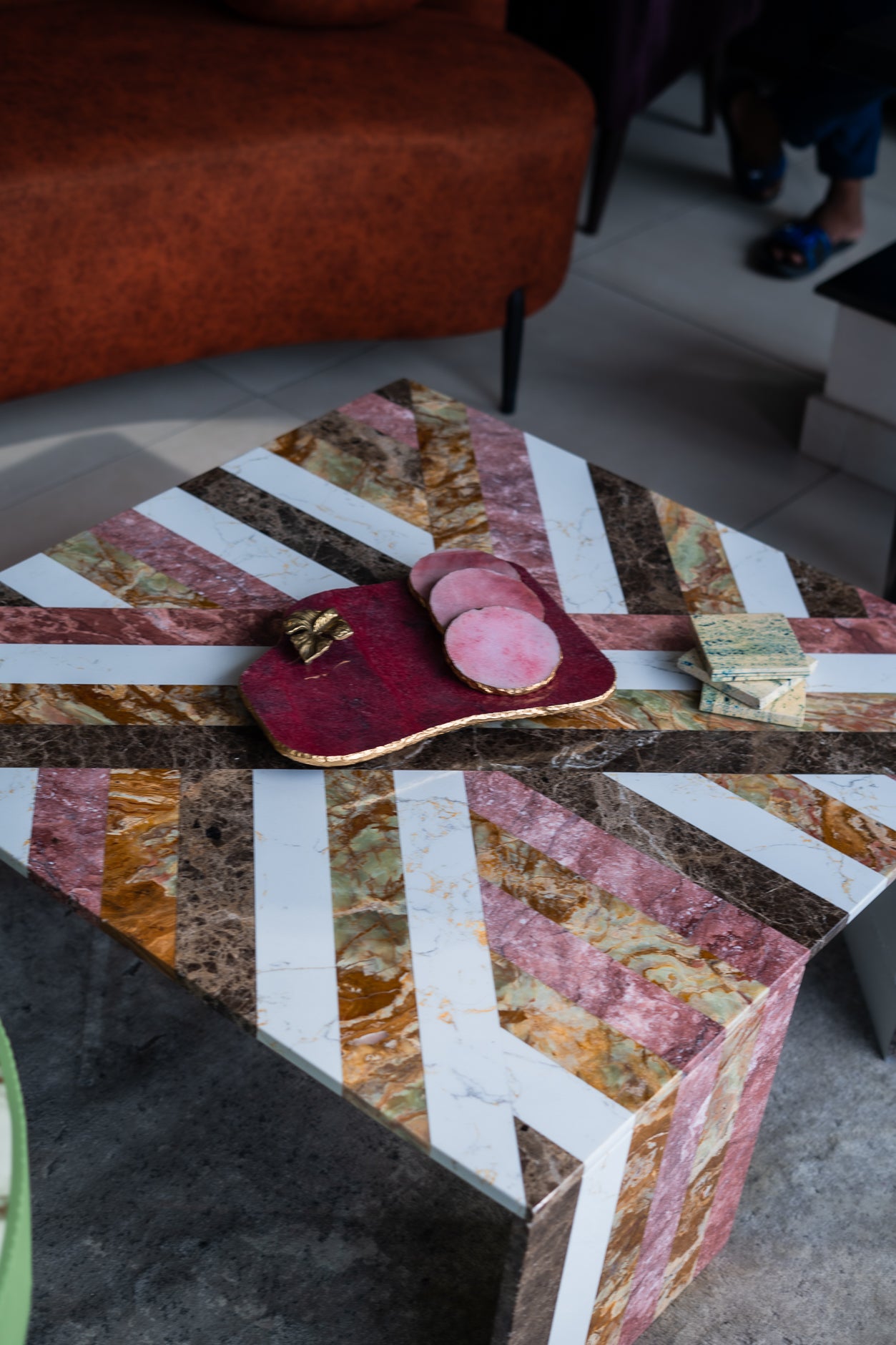 Marble-patterned coffee table with decorative items in a living room setting
