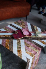 Marble-patterned coffee table with decorative items in a living room setting