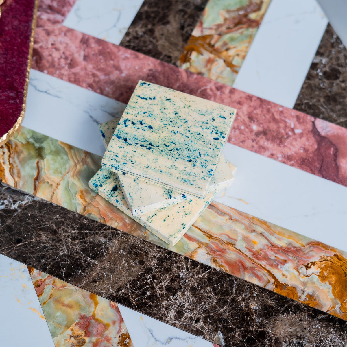 Stack of speckled stone tiles on a marble surface
