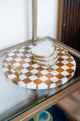 Checkered tray with gold accents on a glass surface