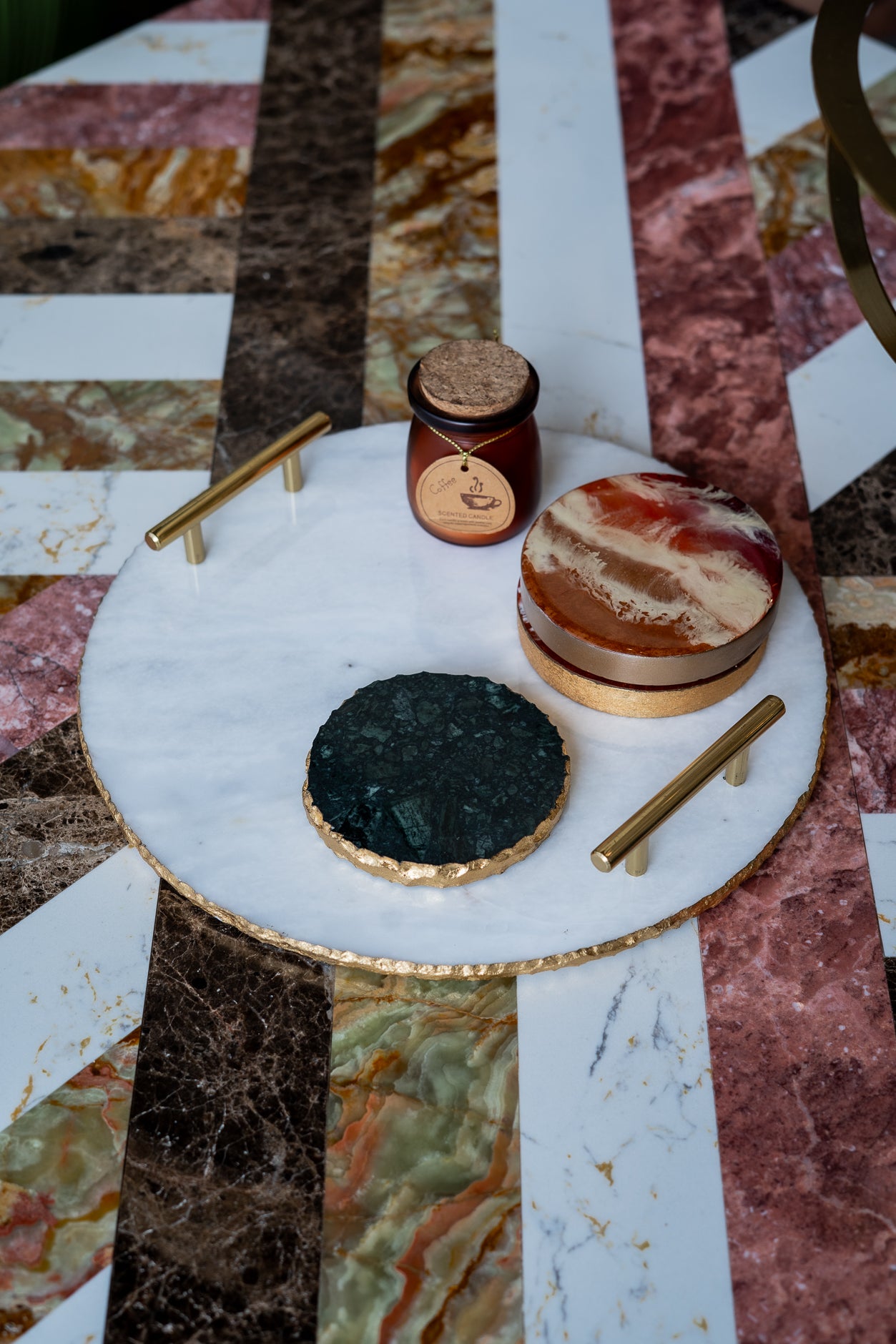 Decorative items on a marble table with a marble floor background
