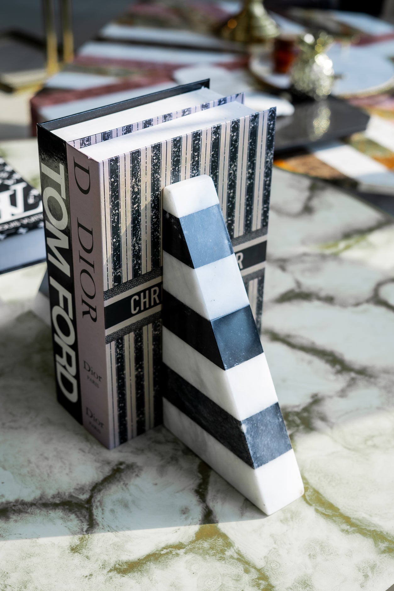 Book with a decorative cover and a striped letter 'A' on a textured surface