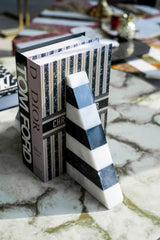 Book with a decorative cover and a striped letter 'A' on a textured surface